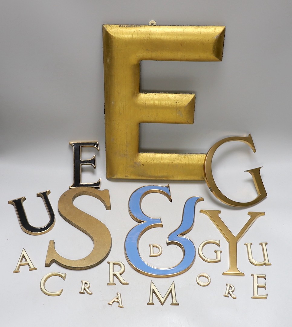 A collection of brass and enamelled lettering of varying sizes and fonts